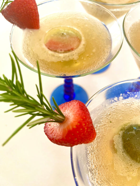 Goddess Greens kombucha mocktail with strawberry and rosemary garnish