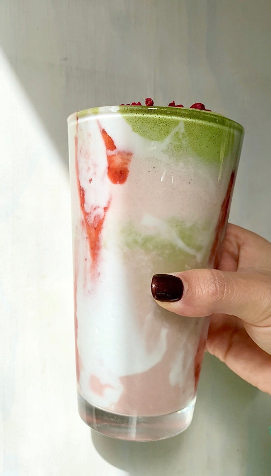 refreshing glass of goddess greens and strawberry as an iced latte